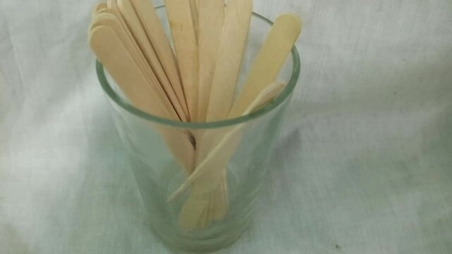 Wooden ice cream sticks in a glass on a light background. photo taken in malysia
