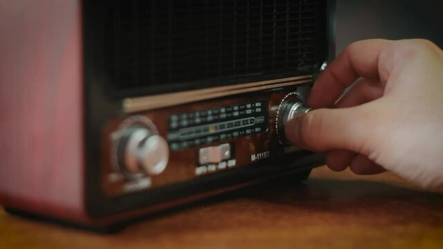 Retro radio tape recorder dial with arrow running through frequencies during channel search. 