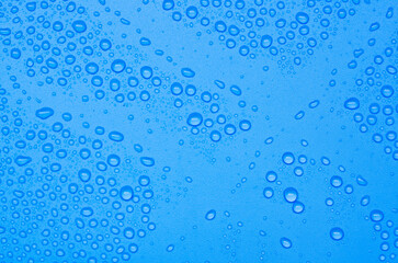 Top view of water droplets on blue gradient color cover background. Water droplets concept