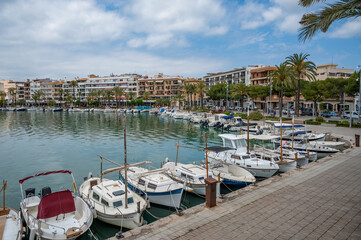 Port Alcudia, Mallorca with small fisher boats and ships anchored at the harbor, wide angle shot...