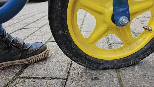 Static close up shot of flat tire of kids bike