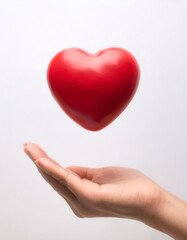 Obraz premium hand holding red heart love floating or flying isolated white background