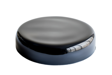 Glossy black hockey puck, isolated on a white background, perfect for sports illustrations and designs.