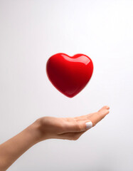 Obraz premium hand holding red heart love floating or flying isolated white background