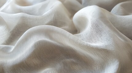 A close-up of soft, shimmering fabric displaying elegant folds and a subtle pattern, perfect for fashion or interior design.