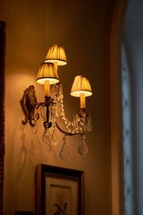 Splendid chandelier with lit candles in a beautiful room of an old mansion