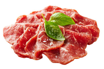 Thinly sliced raw meat garnished with fresh basil leaves on a white isolated background.