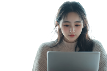 Young woman focused on laptop, secluded environment, modern lifestyle, wearing cozy sweater.