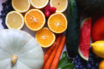 Various seasonal fruits and vegetables on white background. Summer and fall produce. Top view.