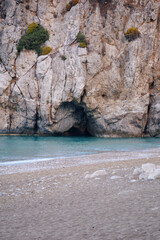 a sea grotto near the beach. Sea cave in a rock by the blue sea