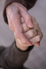 Two elder women holding hands with empathy as a sign of their friendship and love for each other at...