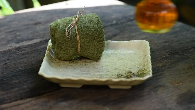 Glycerin soap mixed with gac extract and oil on natural background.