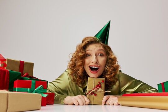 A cheerful young woman posing while wearing a playful party hat in a festive setting. - Powered by Adobe