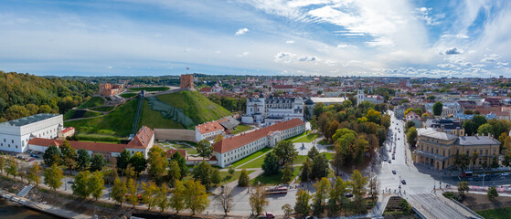 Aerial perspective of Vilnius, Lithuania, featuring Gediminas' Tower on a green hill, with the...
