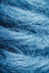 Obraz premium Vertical A close up of a blue yarn with a fuzzy texture.