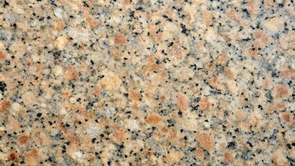 Rough granite surface with visible mineral particles and a speckled texture, rock, stone, nature