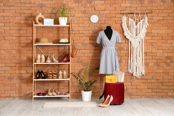 Interior of dressing room with mannequin, pouf and shelf unit