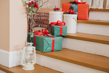 Festively wrapped gifts on warm wooden stairs for the holiday season