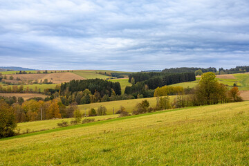Romantic rural autumnal landscape with colorful trees and fields