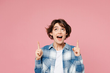 Young shocked surprised woman she wear blue shirt white t-shirt casual clothes point index finger...