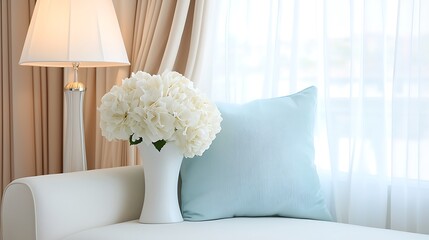 Elegant living room decor featuring fresh white flowers and soft blue accents in a cozy space with natural light