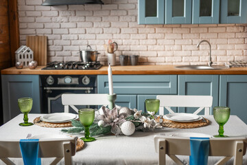 Elegant dining setup in a cozy kitchen with vintage decor and festive accents