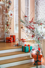 Beautifully decorated staircase with festive gifts showcasing holiday spirit