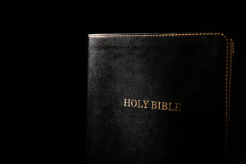 Holy Bible on black background, closeup