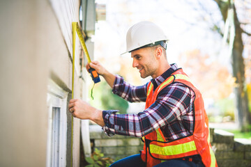 Man inspecting house window outside on day light