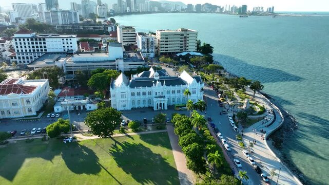 Penang city hall along scenic coastline and lush park in penang malaysia, aerial view