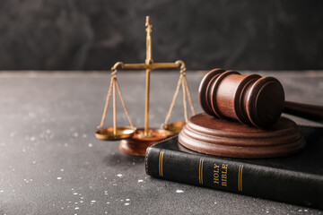Judge's gavel, Holy Bible and justice scales on dark background