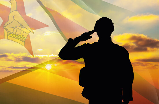 Silhouette of a soldier with a background of the Zimbabwe flag and a sunset or sunrise. Concept of national holidays. Commemoration Day.
