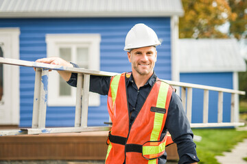 inspector or engineer with ladder checking the building structure and house roof specifications.