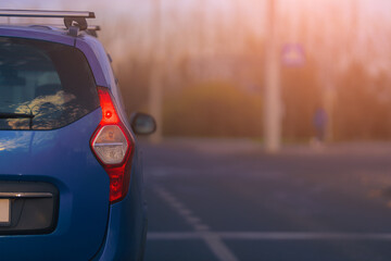 Autumn landscape and view of the road with cars. Orange evening sun and reflections on cars.