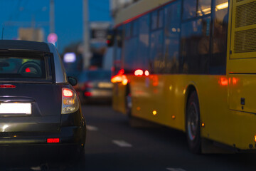 Autumn landscape and view of the road with cars. Orange evening sun and reflections on cars.