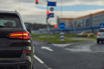 Autumn landscape and view of the road with cars. Orange evening sun and reflections on cars.