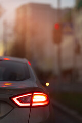 Autumn landscape and view of the road with cars. Orange evening sun and reflections on cars.