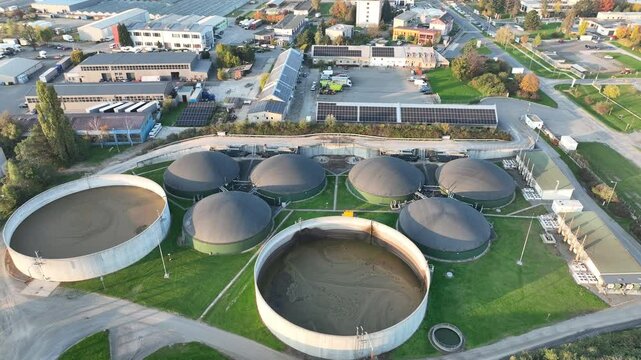 Bio gas station factory plant modern aerial drone view, ecological biomass energy production round roofs biofuel large distribution technological complex, technology distillation pollution, Europe