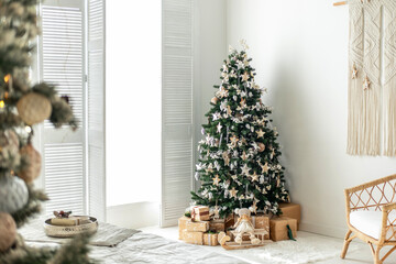 Cozy Christmas tree adorned with decorations and gifts in a bright living room