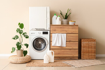Interior of laundry room with washing machine, detergents and commode