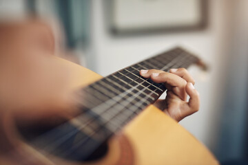 Person, hand and guitar in home for music, learning and skill development in rehearsal. Zoom,...