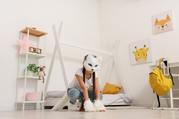 Quadrober girl with cat mask in bedroom