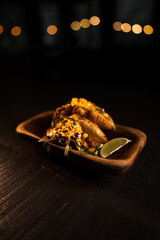 Taco with lime and vegetables in a plate on a black background.Mexican cuisine concept
