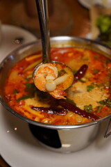Thai Tom Yum Kung soup in a Hot Pot bowl