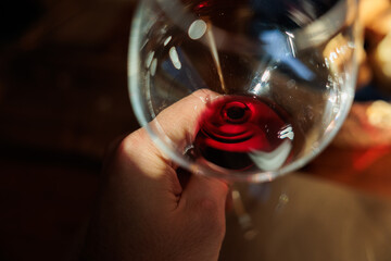guardando dentro ad un bicchiere riempito con del vino rosso