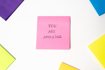 You are Amazing message on sticky note isolated on white background with copy space