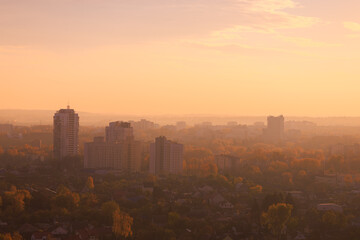 Fototapeta premium Evening view of the city. Sunset orange sky and beautiful cityscape, buildings and city streets, public place