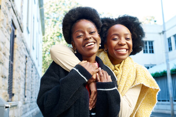 Joyful Friends Embracing Outdoors in the City on a Bright Day