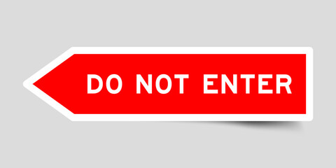 Red color arrow shape sticker label with word do not enter on gray background