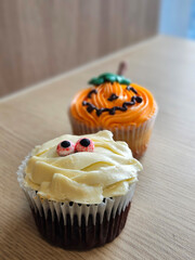 Cute Halloween decoration cup cake on the timber floor